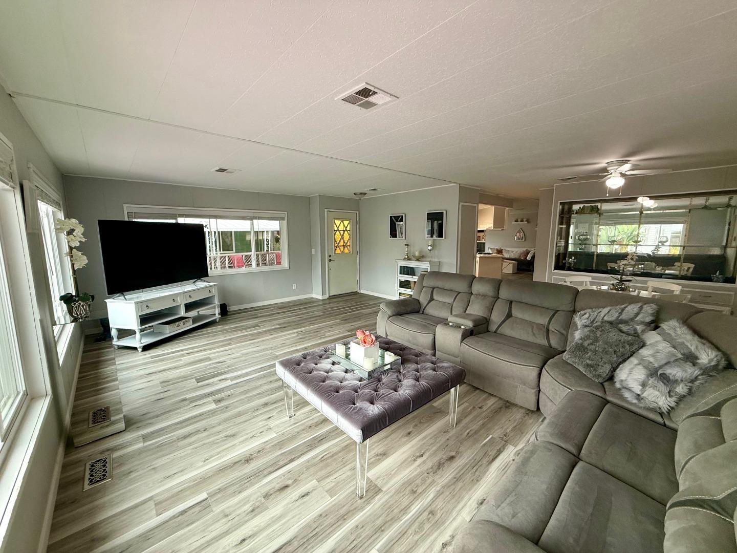 6130 Monterey Road, Unit 201 San Jose, CA 95138 - Photo 2 of 13 a living room with furniture and a flat screen tv