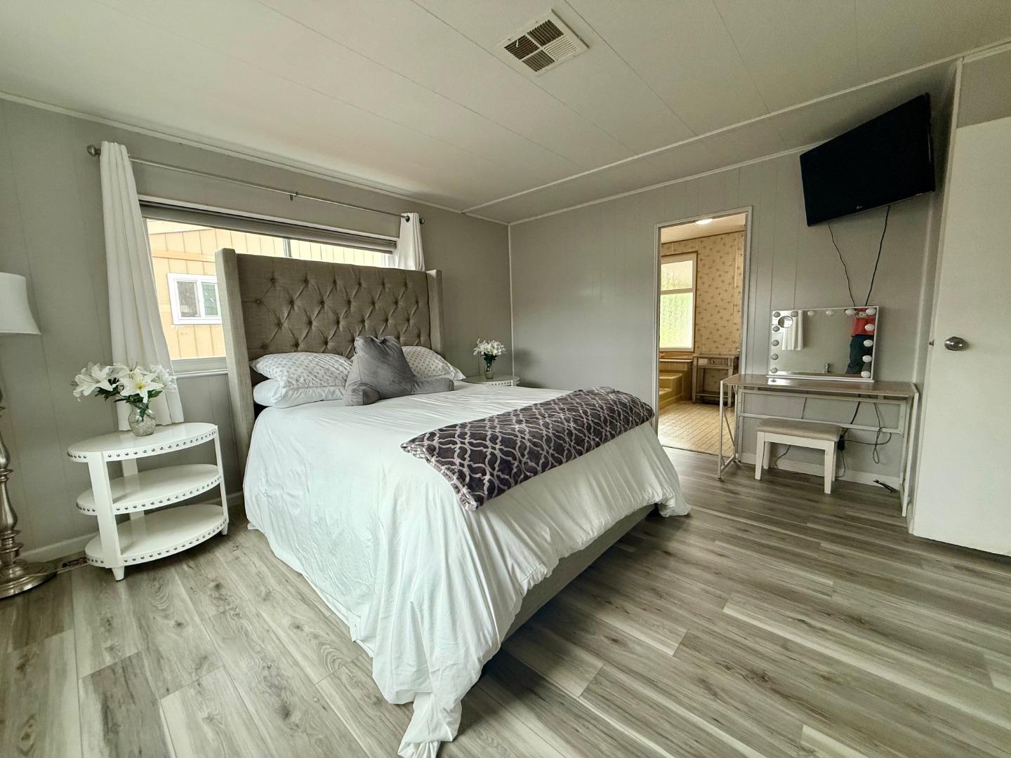 6130 Monterey Road, Unit 201 San Jose, CA 95138 - Photo 5 of 13 a bedroom with a bed and a view of living room