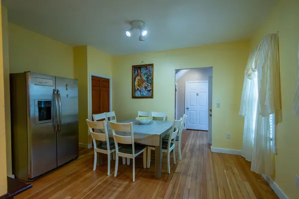 a view of a dining room with furniture and wooden floor