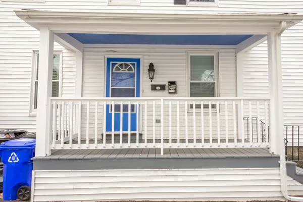 a view of a house that has a small deck