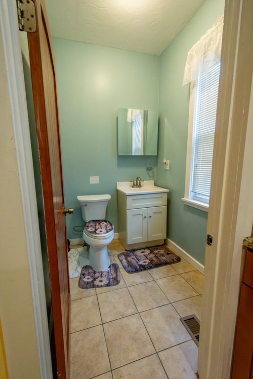 816 River Street, Unit 1 Boston, MA 02136 - Photo 4 of 16 a bathroom with a toilet sink and mirror