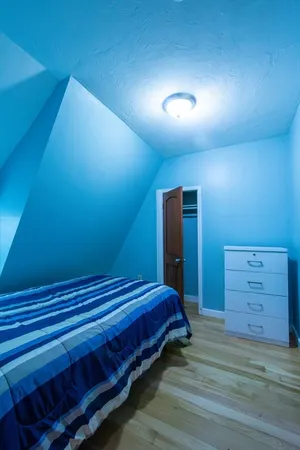 a bedroom with a bed and a dresser