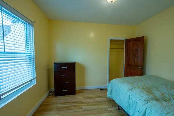 a bedroom with a bed and a closet