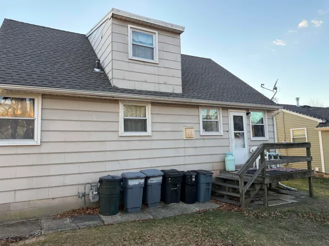 a view of house with outdoor seating area