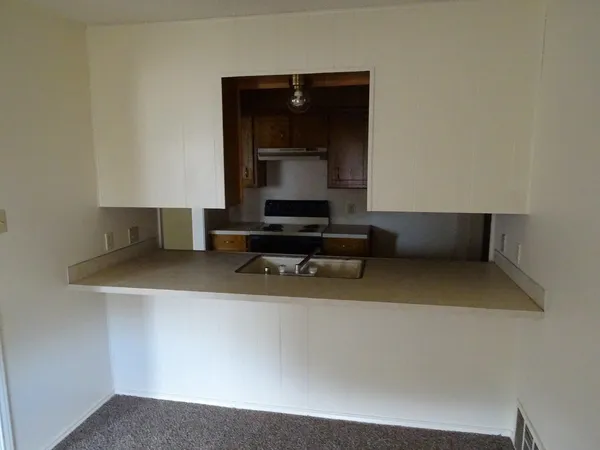 a living room with a couch and a wall painting