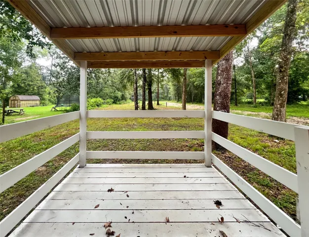 a view of a porch with wooden floor and outdoor space