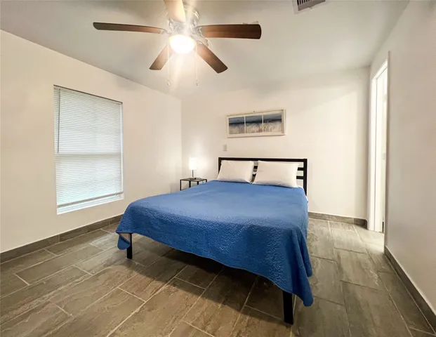 a bedroom with a bed and a window