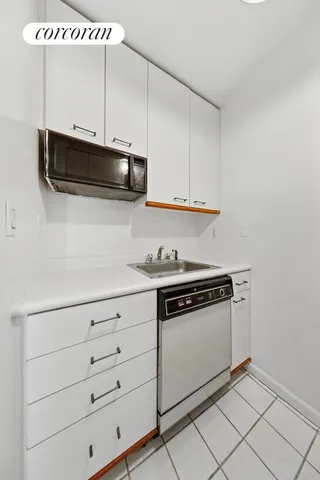 a kitchen with granite countertop a refrigerator a stove a microwave and cabinets