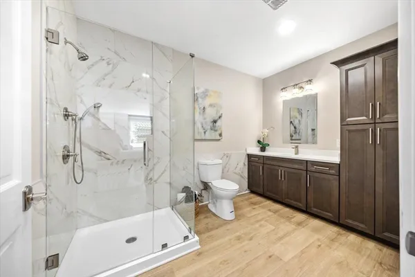 a bathroom with a tub sink toilet and shower
