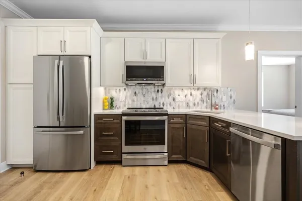 a kitchen with a refrigerator and a sink