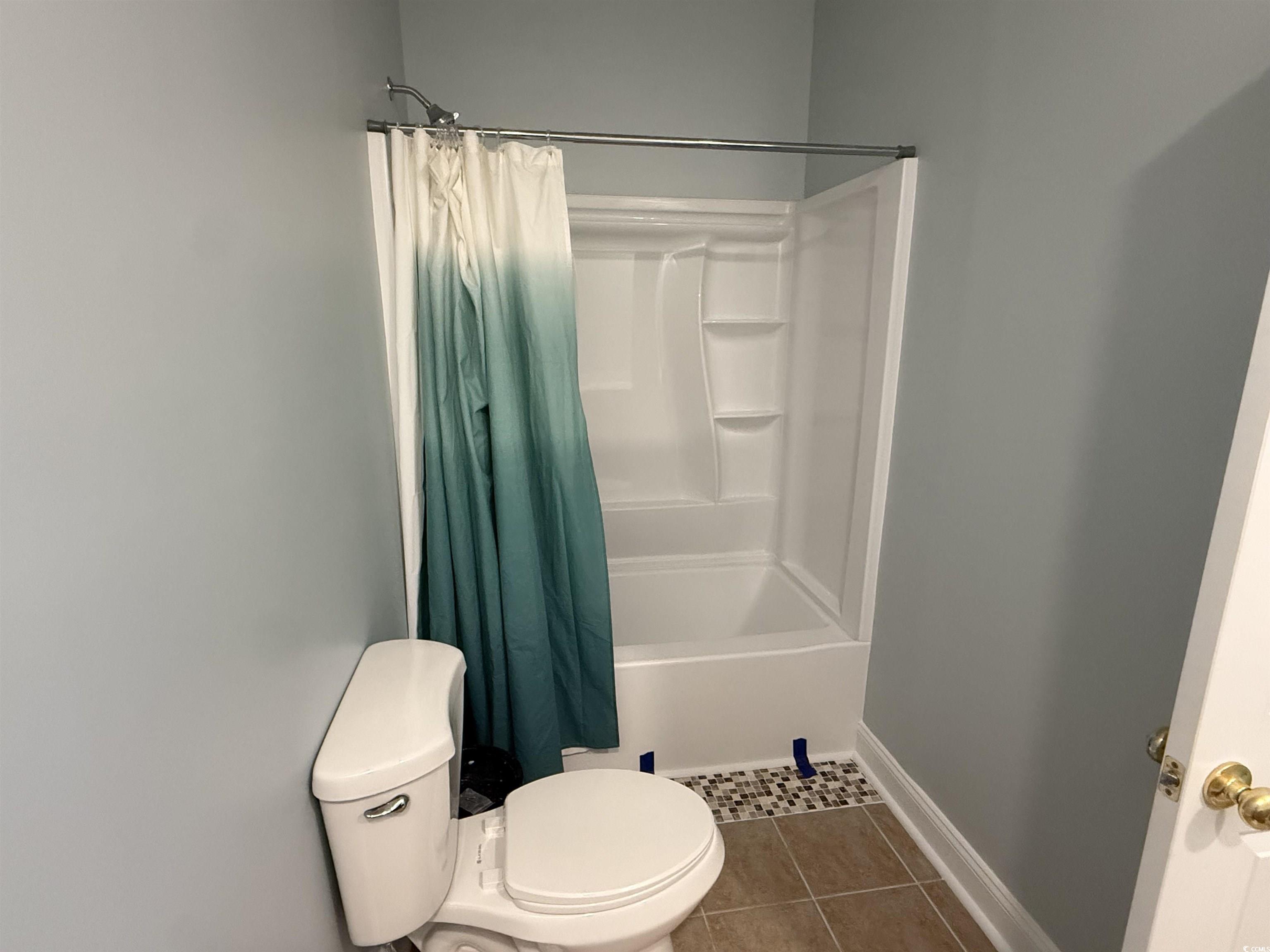 5858 Longwood Drive, Unit #204 Murrells Inlet, SC 29576 - Photo 10 of 13 Full bath featuring tile patterned flooring and shower / bathtub combination with curtain