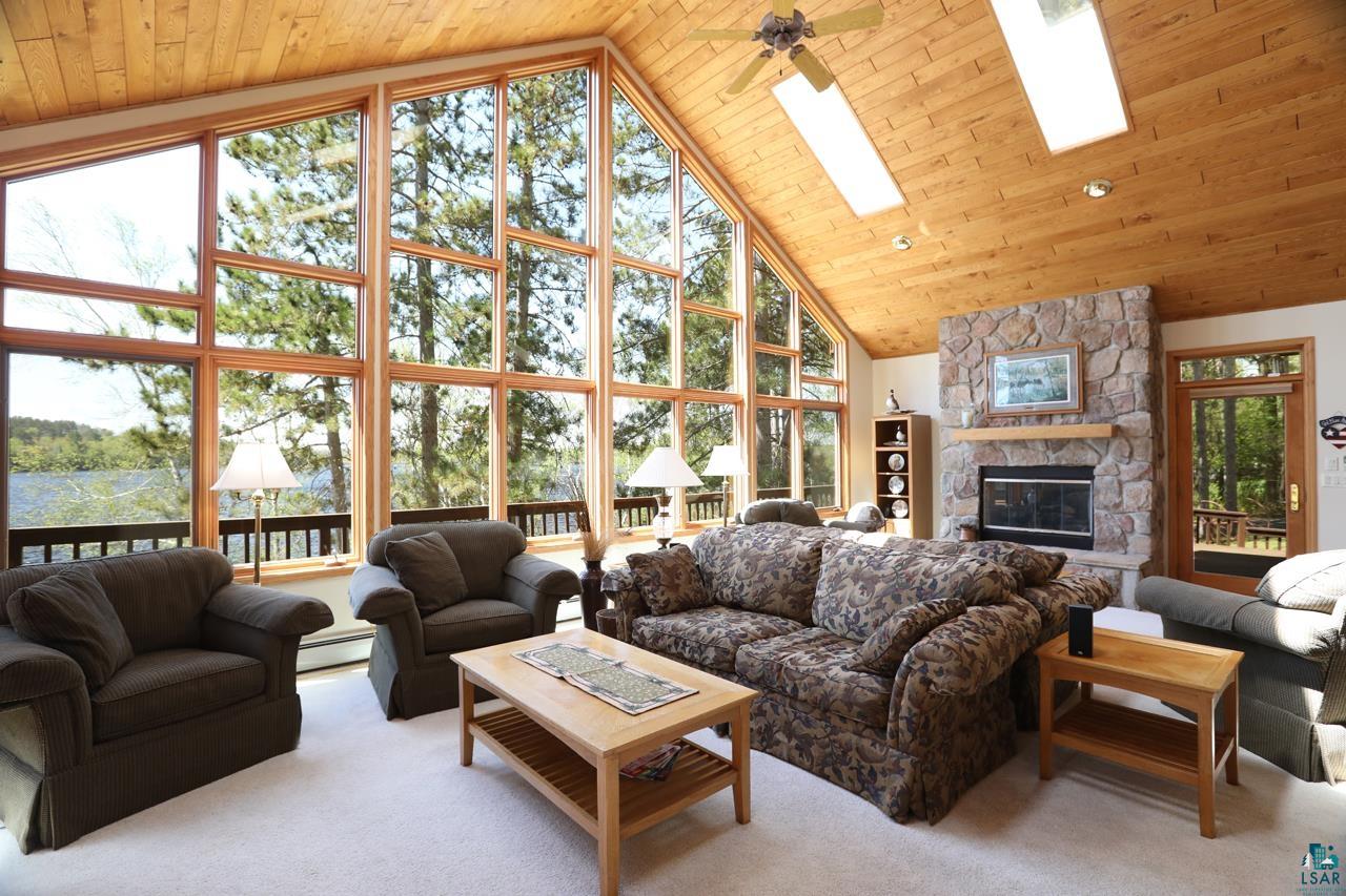 1880 Everett Bay Road Tower, MN 55790 - Photo 3 of 50 Living room with a baseboard radiator, healthy amount of natural light, high vaulted ceiling, and wood ceiling