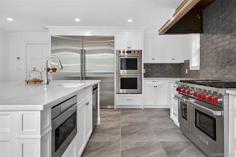 a kitchen with a sink stove and cabinets