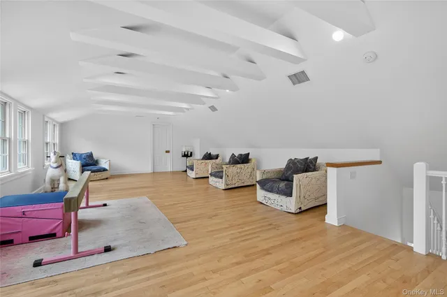 a bedroom with furniture and a wooden floor