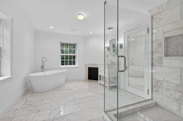 a bathroom with a bathtub and shower