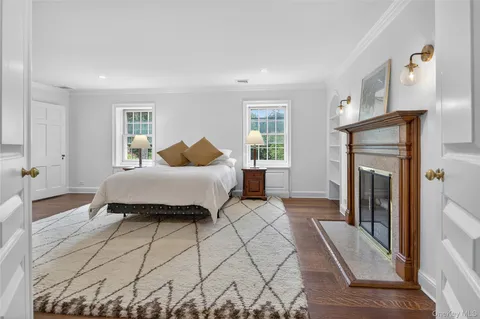 a bedroom with a bed and a fireplace