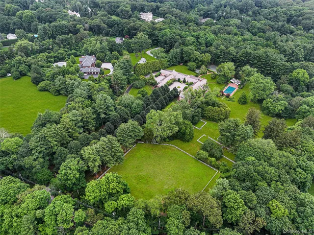 an aerial view of a residential houses with yard and swimming pool