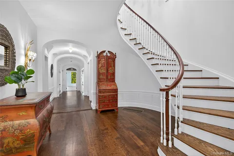 a view of entryway with wooden floor and stairs