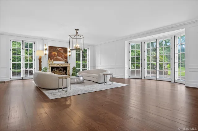 a living room with fireplace furniture and a large window