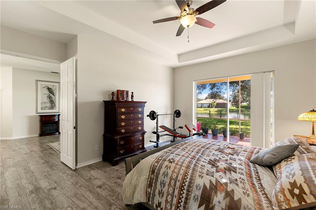 860 Grand Rapids Boulevard Naples, FL 34120 - Photo 11 of 44 a bedroom with a bed and a chandelier