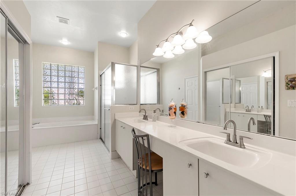 860 Grand Rapids Boulevard Naples, FL 34120 - Photo 12 of 44 a bathroom with a tub sink and mirror