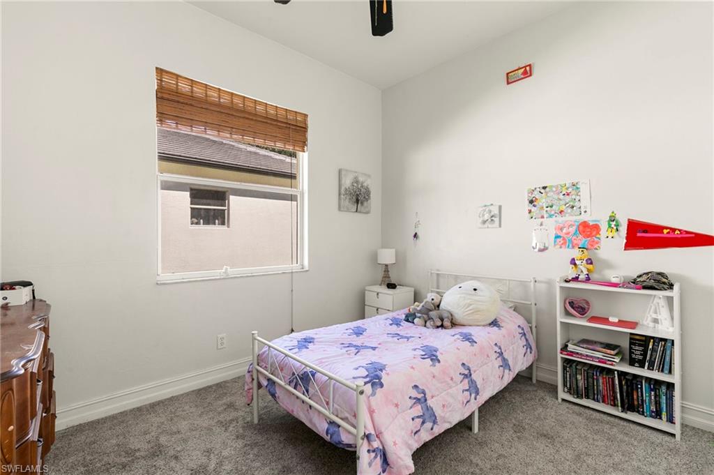 860 Grand Rapids Boulevard Naples, FL 34120 - Photo 19 of 44 a bedroom with a bed and a window