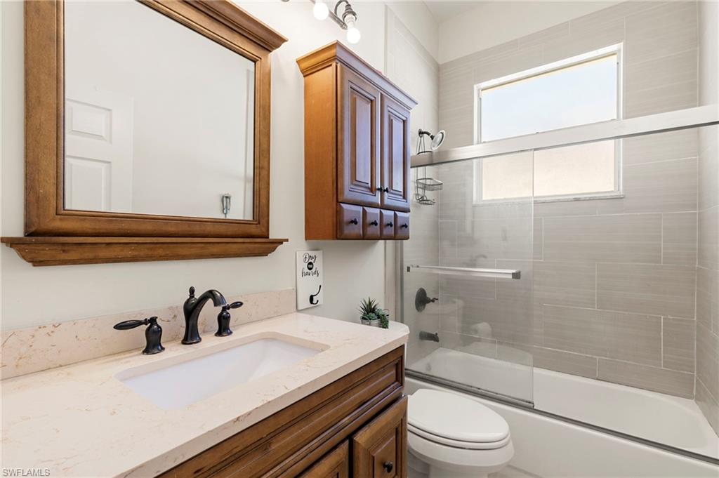 860 Grand Rapids Boulevard Naples, FL 34120 - Photo 20 of 44 a bathroom with a sink a toilet and a bathtub