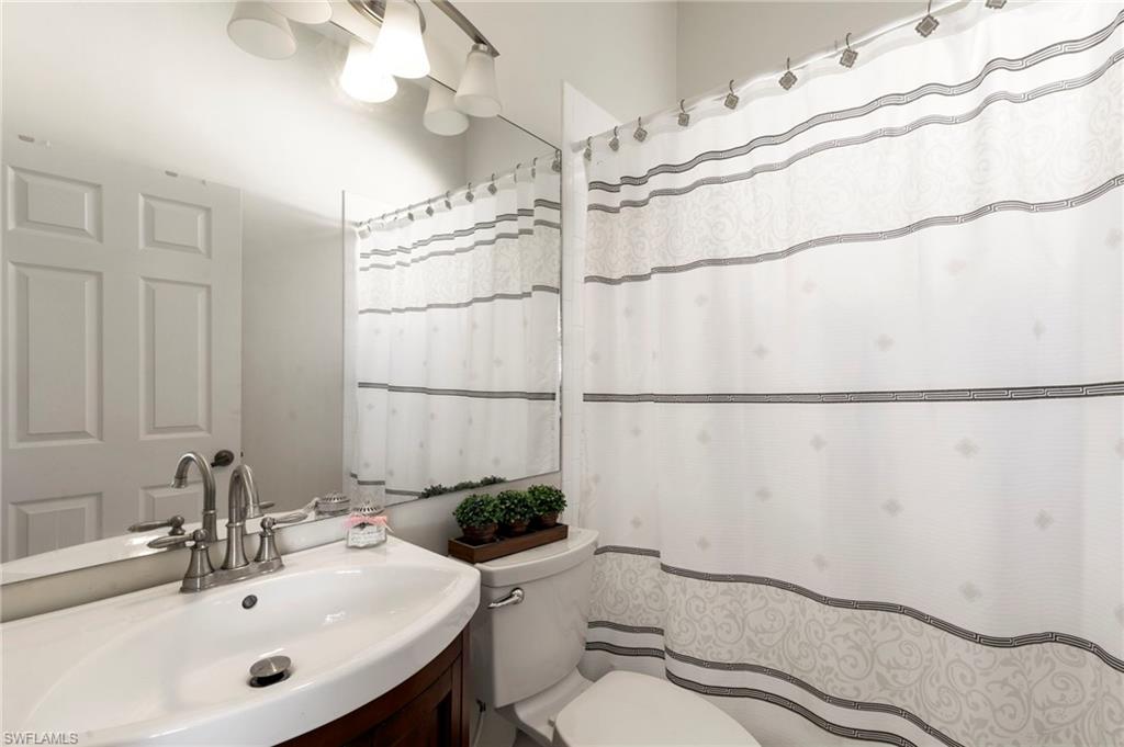 860 Grand Rapids Boulevard Naples, FL 34120 - Photo 22 of 44 a bathroom with a sink mirror vanity and toilet