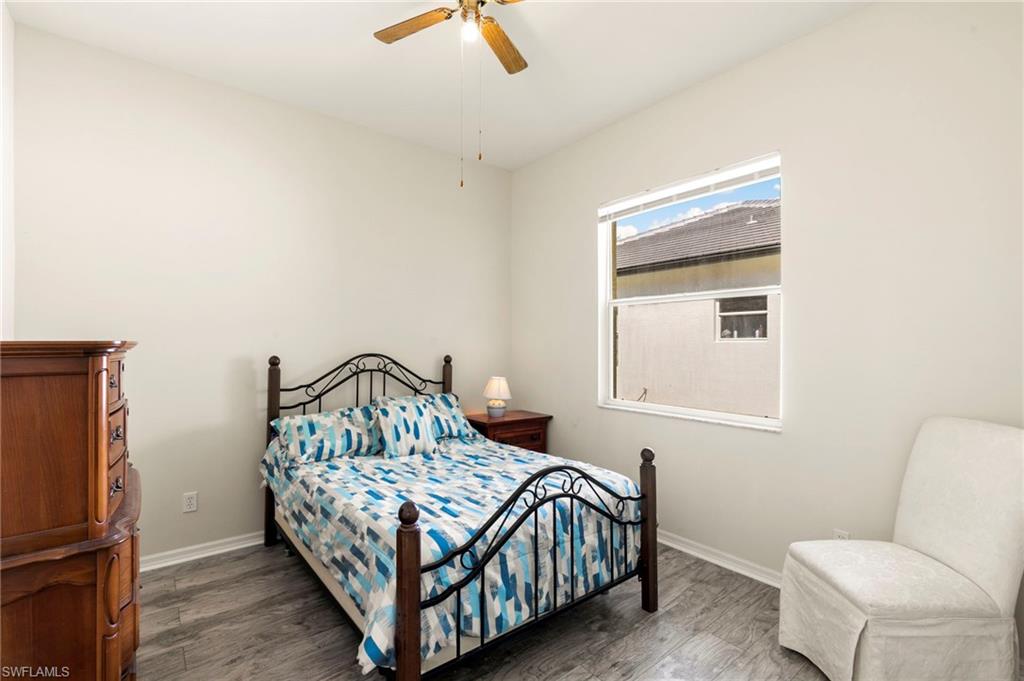 860 Grand Rapids Boulevard Naples, FL 34120 - Photo 23 of 44 a bedroom with a bed and wooden floor