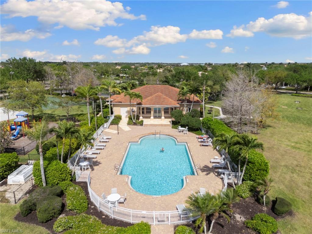 860 Grand Rapids Boulevard Naples, FL 34120 - Photo 27 of 44 a view of a swimming pool with a garden and trees