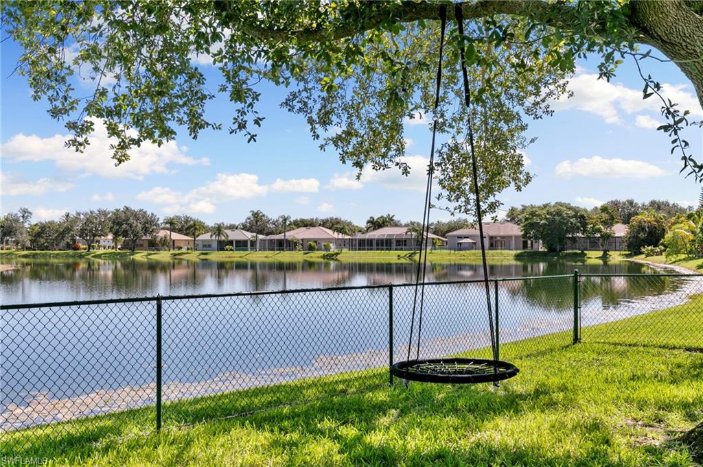 860 Grand Rapids Boulevard Naples, FL 34120 - Photo 29 of 44 a lake view with a wrought fence