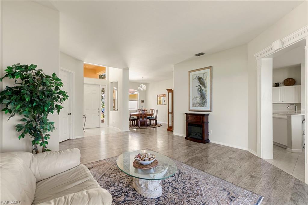 860 Grand Rapids Boulevard Naples, FL 34120 - Photo 3 of 44 a living room with furniture and a wooden floor