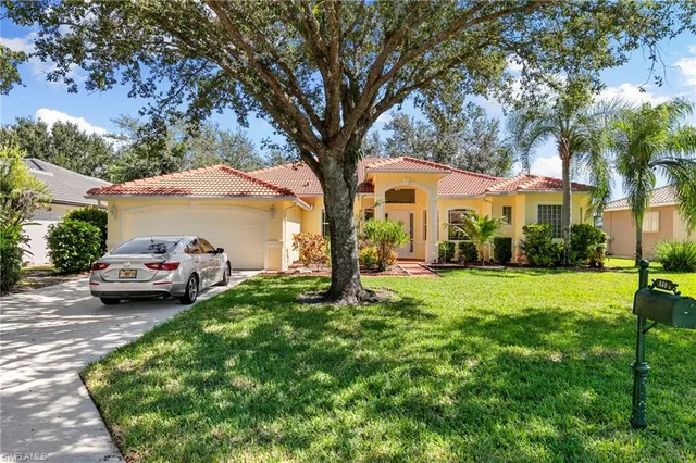 an aerial view of a house with a lake view