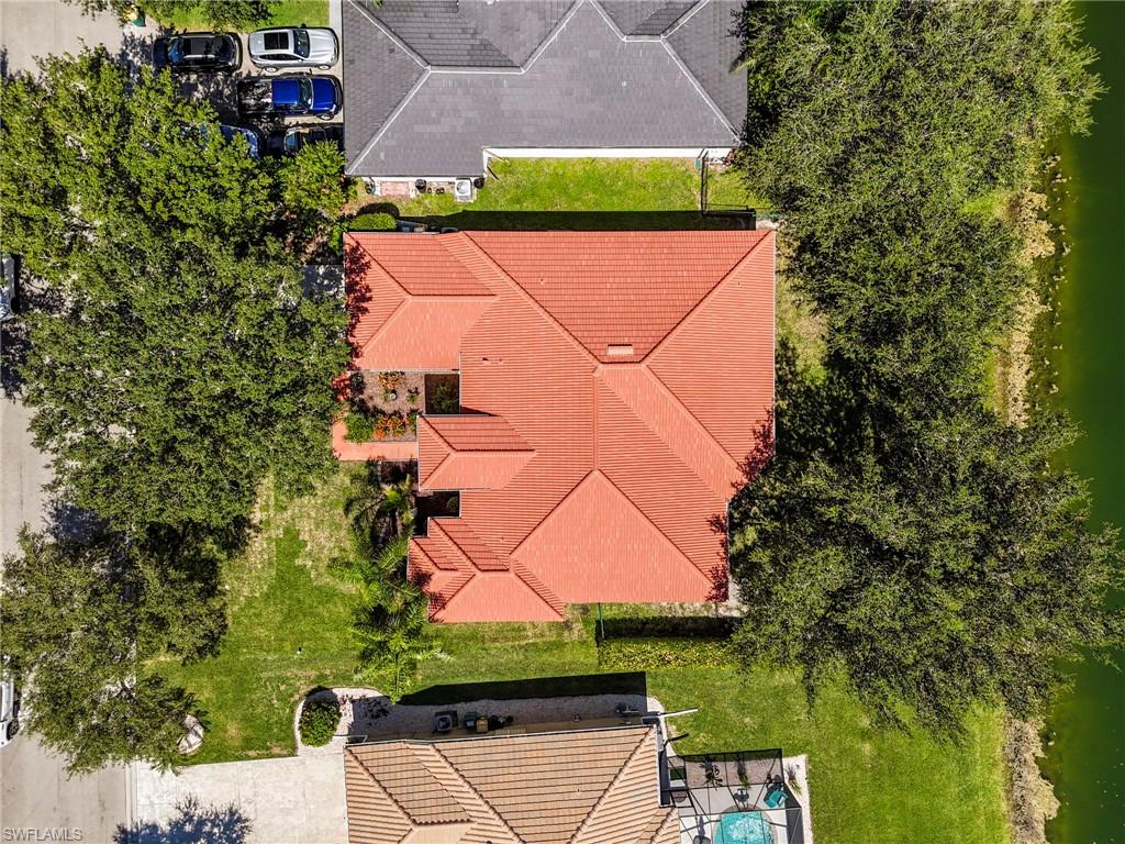 860 Grand Rapids Boulevard Naples, FL 34120 - Photo 40 of 44 an aerial view of a house with a yard and a large tree