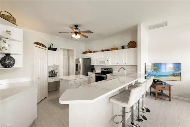 a kitchen with stainless steel appliances kitchen island granite countertop a sink and cabinets