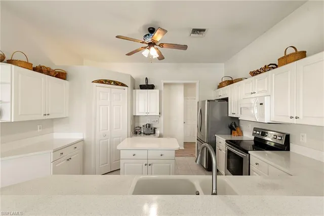 a kitchen with stainless steel appliances a sink stove and cabinets