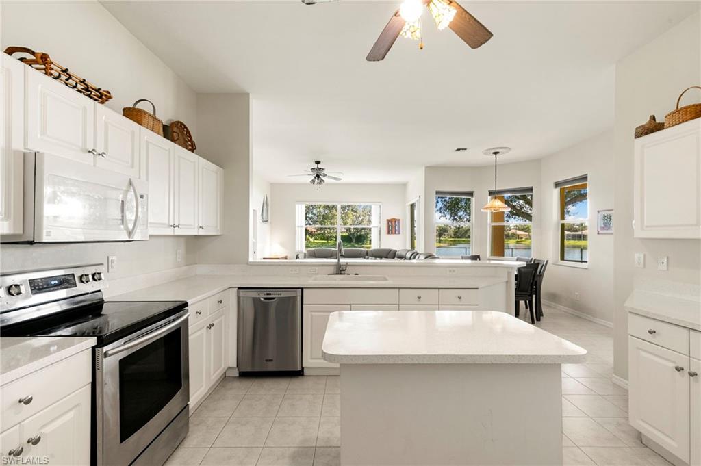 860 Grand Rapids Boulevard Naples, FL 34120 - Photo 6 of 44 a kitchen with stainless steel appliances a sink stove and cabinets