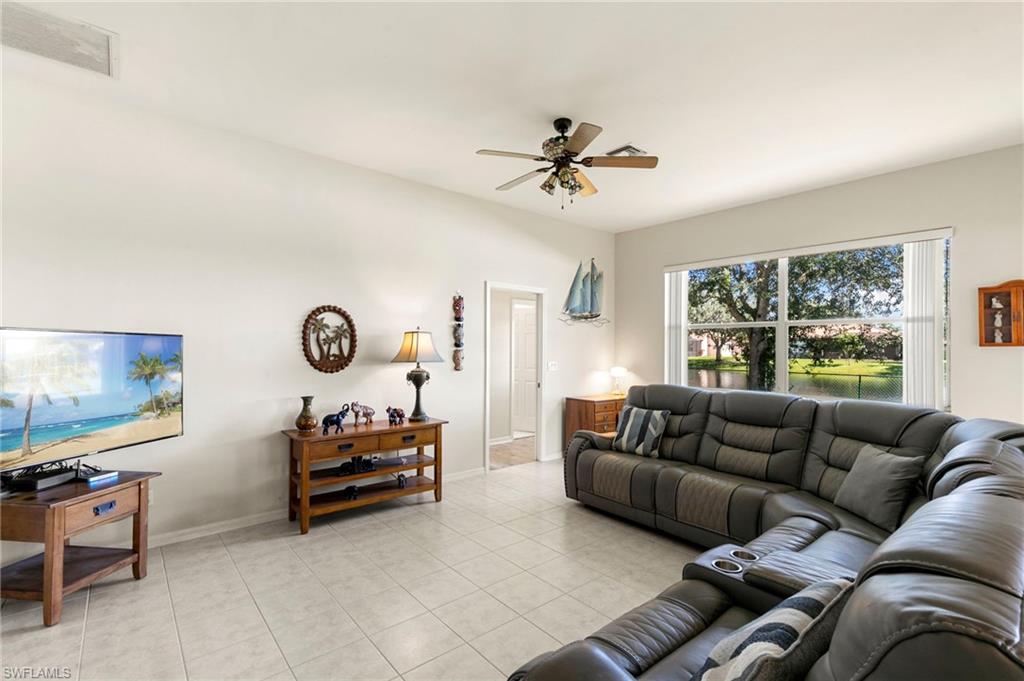 860 Grand Rapids Boulevard Naples, FL 34120 - Photo 9 of 44 a living room with furniture a couch and a flat screen tv