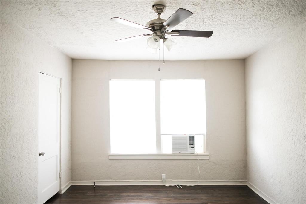 4107 Herschel Avenue, Unit 9 Dallas, TX 75219 - Photo 3 of 9 an empty room with a window and a ceiling fan