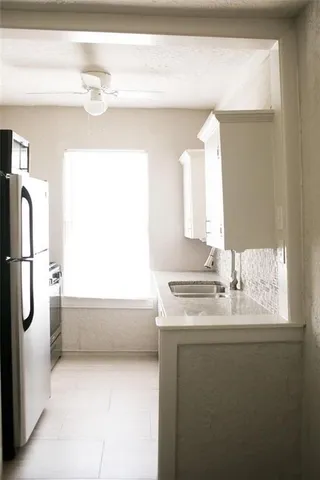 a bathroom with a granite countertop sink a large mirror and a bathtub