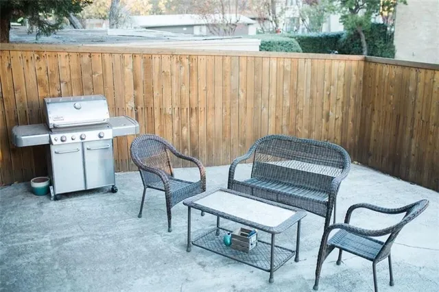 a balcony with a bench and a grill
