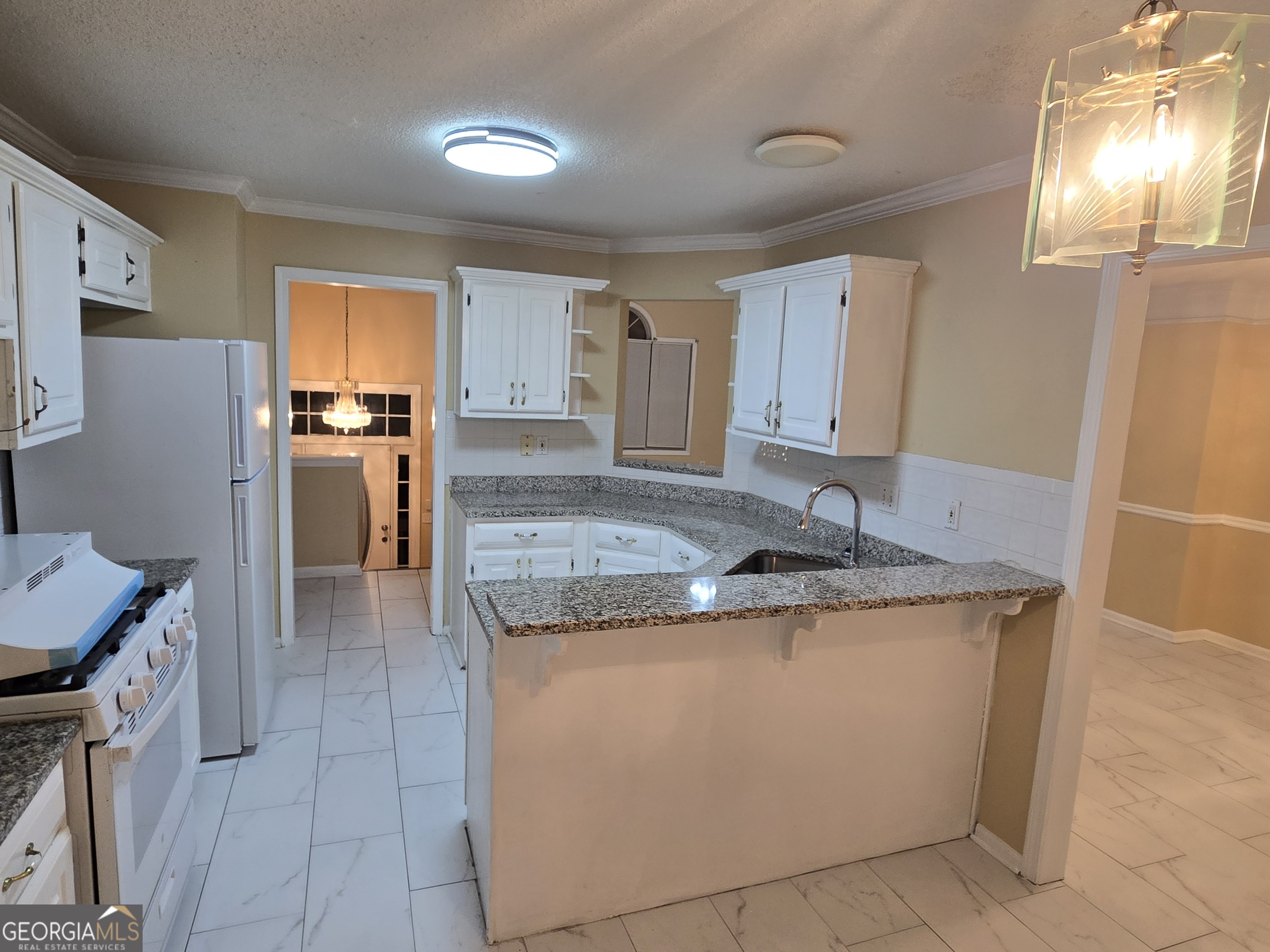 7486 Conkle Road Jonesboro, GA 30236 - Photo 4 of 13 a kitchen with stainless steel appliances granite countertop a sink stove and refrigerator