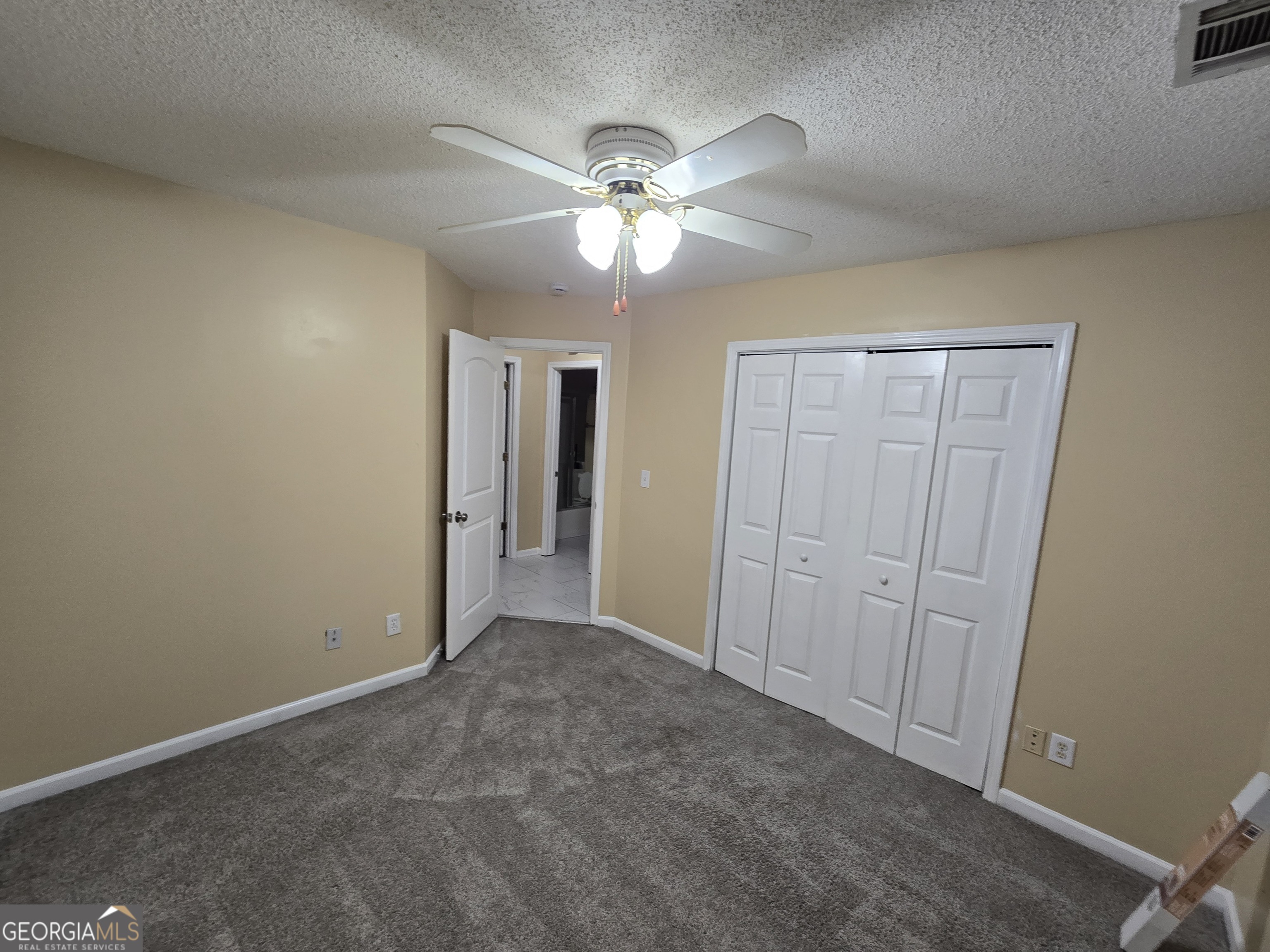 7486 Conkle Road Jonesboro, GA 30236 - Photo 6 of 13 an empty room with closet and a chandelier fan