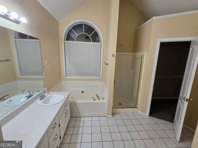 a white toilet sitting next to a bathroom sink and a mirror