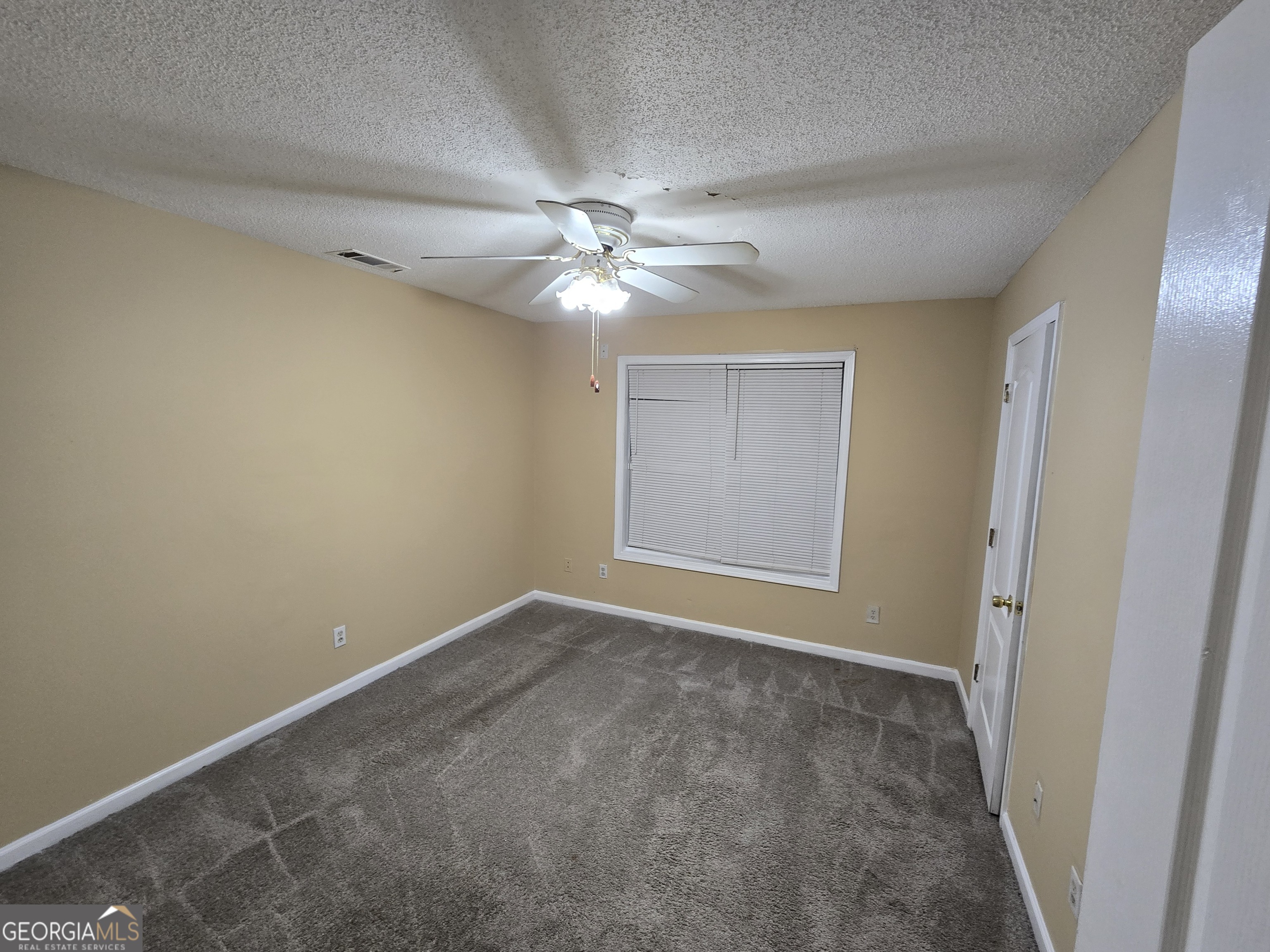7486 Conkle Road Jonesboro, GA 30236 - Photo 10 of 13 an empty room with windows and fan
