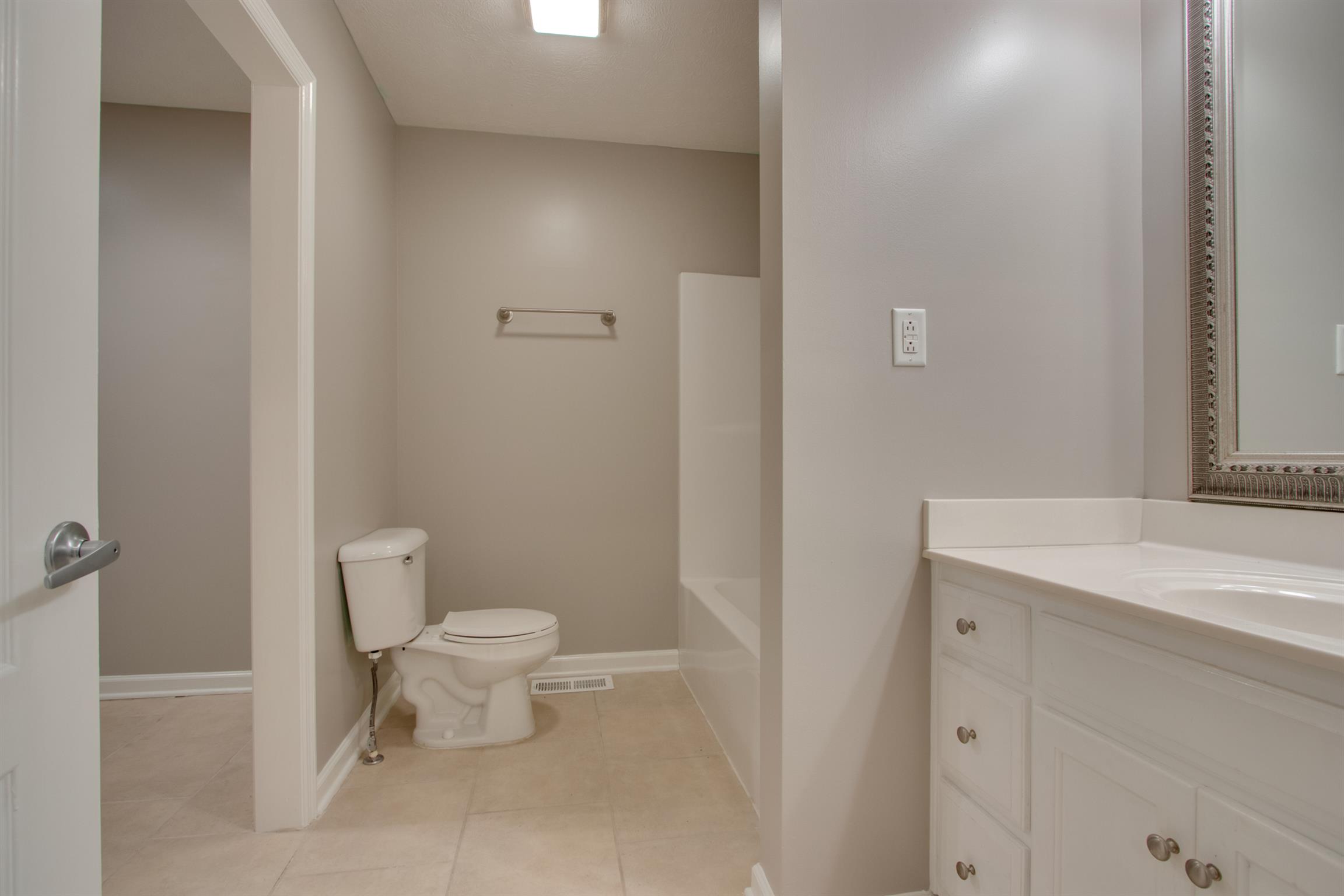 201 High Street Alexandria, TN 37012 - Photo 16 of 23 a bathroom with a toilet sink and a mirror