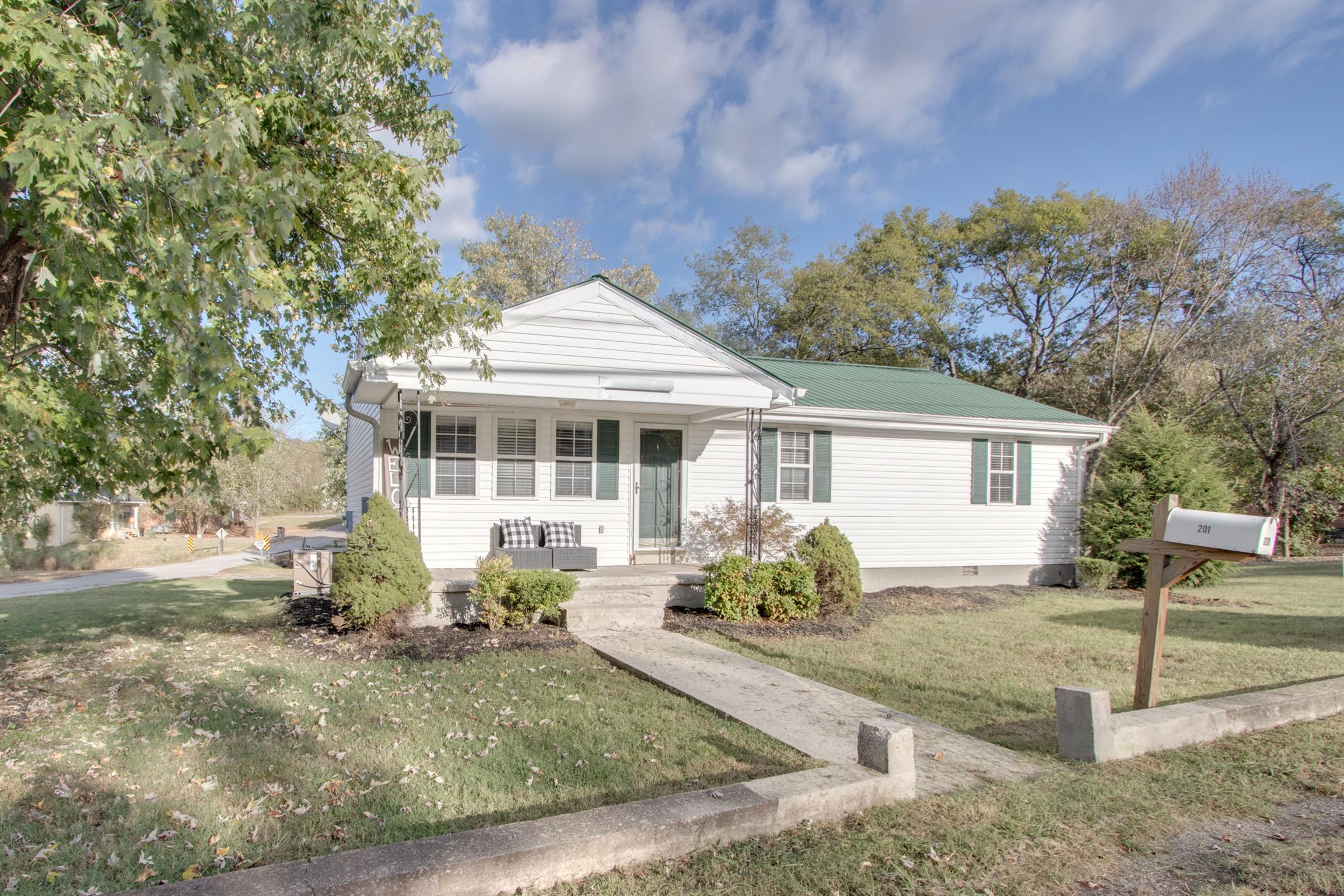 201 High Street Alexandria, TN 37012 - Photo 2 of 23 a front view of a house with garden