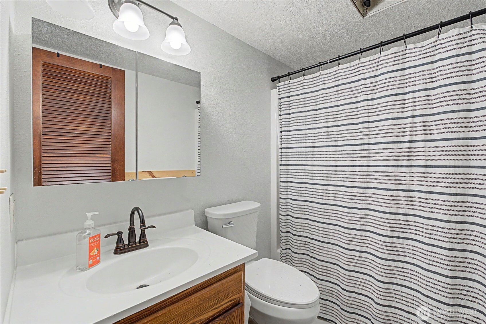 1611 Ham Hill Road Centralia, WA 98531 - Photo 26 of 40 a bathroom with a sink a toilet and shower curtain