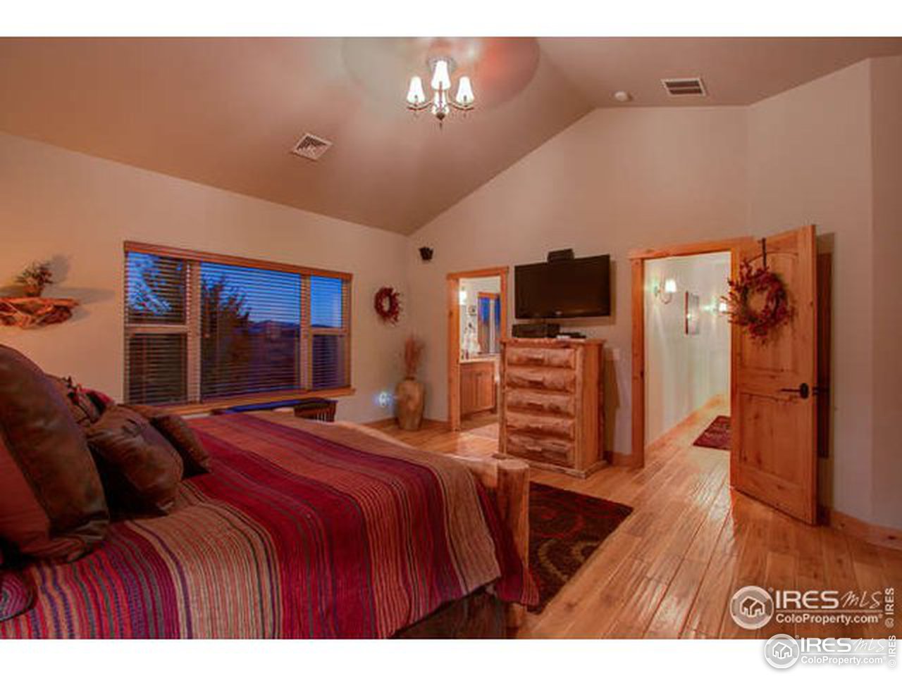 1441 Shelby Drive Berthoud, CO 80513 - Photo 23 of 40 a bedroom with a bed and a flat screen tv
