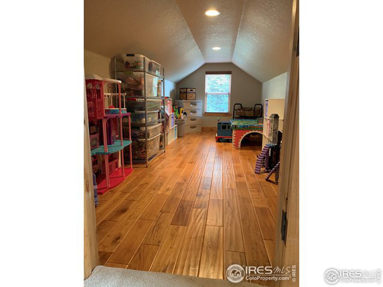 1441 Shelby Drive Berthoud, CO 80513 - Photo 27 of 40 a living room with furniture and a book shelf